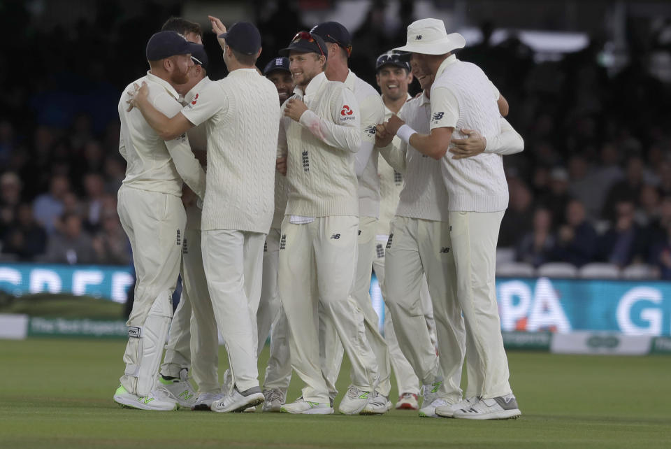 England's players celebrate taking the wicket of India's Cheteshwar Pujara during the second day of the second test match between England and India at Lord's cricket ground in London, Friday, Aug. 10, 2018. (AP Photo/Kirsty Wigglesworth)