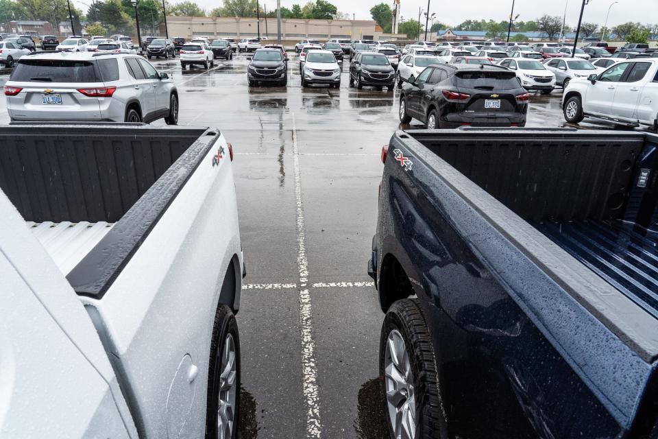 Empty spaces where new vehicles would be parked are seen in the lot of Matick Chevrolet in Redford on Monday, May 3, 2021. The dealership has spaced the 200 vehicles they have on the lot as they are down from the usual 1,000 vehicles while inventory is affected by parts shortages.