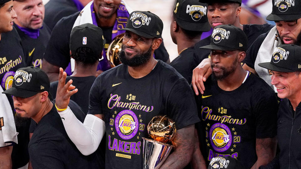 Seen here, LeBron James poses with his trophy after winning the 2020 NBA championship.