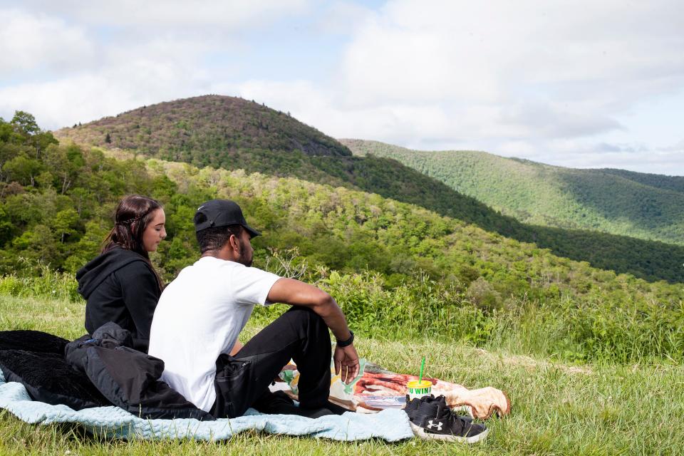 Rose Ivory, left, and Auston Lackey have a picnic along the Blue Ridge Parkway during Memorial Day weekend May 30, 2021.