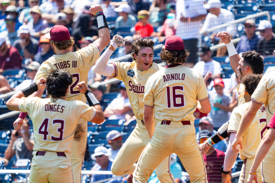 Florida State shortstop Alex Lodise, center, celebrates with teammates after hitting a home run in Sunday's elimination game win over Virginia.