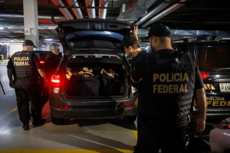 Federal police officers leave the headquarters of the Liberal Party during an operation targeting some of former President Jair Bolsonaro's top aides in Brasilia