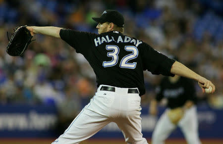FILE PHOTO: Toronto Blue Jays starter Roy Halladay pitches against the Minnesota Twins during the first inning of their Major League Baseball game in Toronto, Ontario, Canada, May 29, 2005. REUTERS/Jim Ross/File Photo