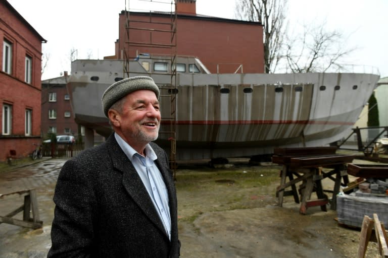 Ship Captain Waldemar Rzeznicki stands in front of a steel schooner named 'Father Boguslaw' under construction, at the courtyard of a homeless shelter run by Catholic Fathers, in Warsaw