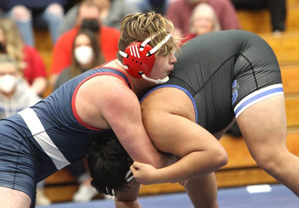 BNL senior Javi Paredes (left) duels with Columbus North's Alexander Lozano in the 220-pound match Thursday night.