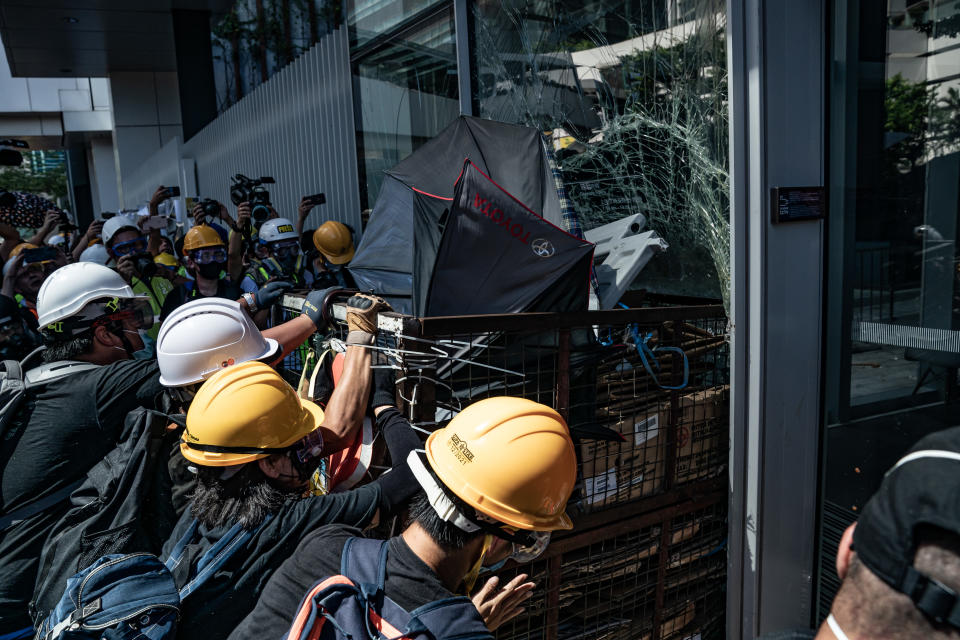 Protesters smash glass doors and windows of the Legislative Council Complex on July 1, 2019 in Hong Kong, China. (Photo: Anthony Kwan/Getty Images)