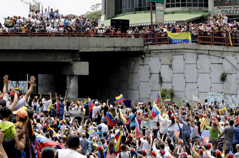 Supporters of opposition leader Juan Guaido, Venezuela's self-proclaimed interim president, cheer for him during a rally at San Antonio de Los Altos, Miranda State, Venezuela, Saturday, March 30, 2019. Guaido took his campaign for change to one of the country's most populous states on Saturday, while supporters of the man he is trying to oust, President Nicolas Maduro, held a rival demonstration in the capital after another nationwide blackout. (AP Photo/Natacha Pisarenko)