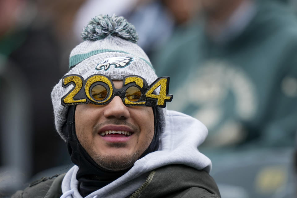 A spectator wears 2024 glasses in honor of the New Year prior to an NFL football game between the Philadelphia Eagles and the Arizona Cardinals, Sunday, Dec. 31, 2023, in Philadelphia. (AP Photo/Matt Slocum)