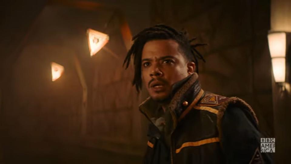 Jacob Anderson, as Vinder in Doctor Who, wearing a high-collared jacket, standing in a spaceship of some kind, in Doctor Who.