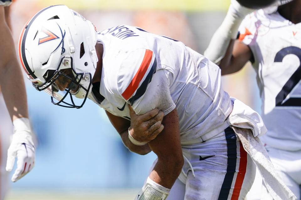 Virginia quarterback Tony Muskett, grabs his arm after being sacked by a Tennessee defender in the second half of an NCAA college football game Saturday, Sept. 2, 2023, in Nashville, Tenn. Tennessee won 49-13. (AP Photo/George Walker IV)