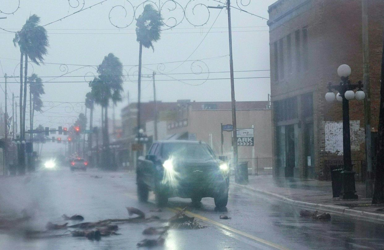 A pickup truck drives around fallen debris and palm trees in the Ybor City neighborhood ahead of Hurricane Ian making landfall on September 28, 2022 in Tampa, Florida.