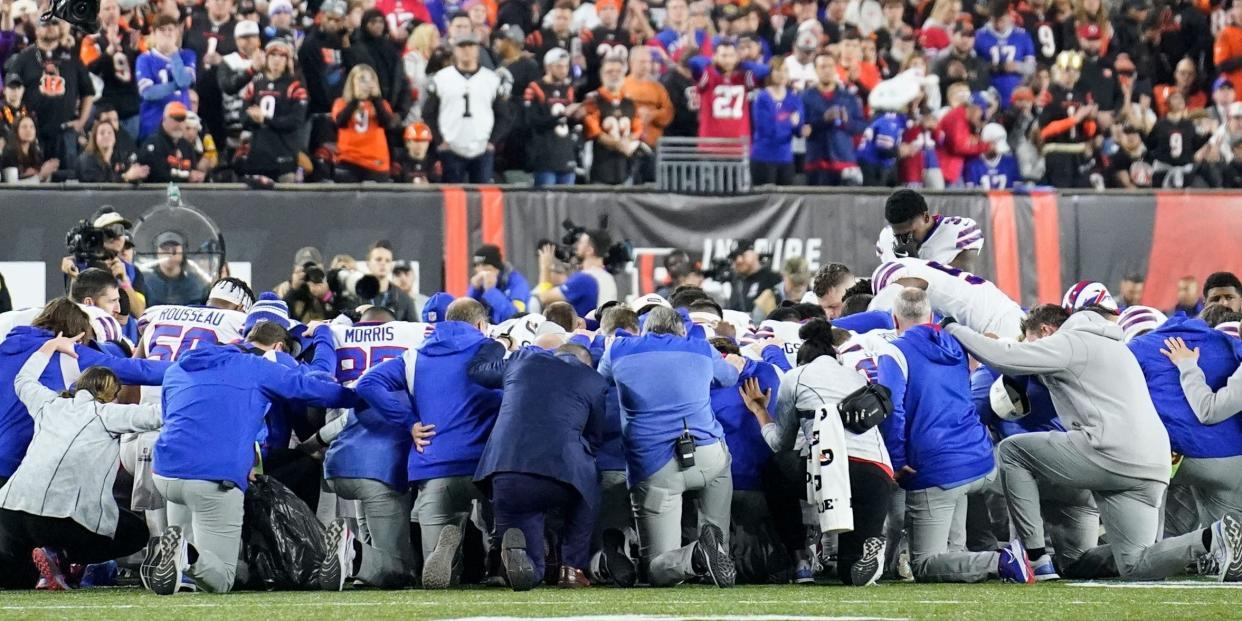 Bills players gather to pray after teammate Damar Hamlin collapsed on the field.