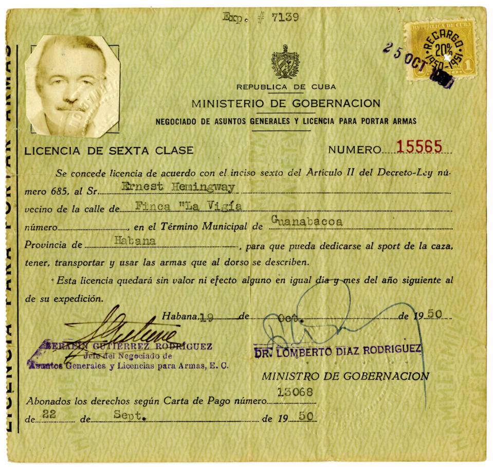 This photo released Tuesday, Feb. 11, 2014 by the John F. Kennedy Presidential Library and Museum in Boston, shows Ernest Hemingway’s 1950 license to carry arms in Cuba, one of many new items from his former Cuban estate being made available at the museum. To date, the Kennedy Library has the world’s largest collection of Hemingway’s life and work, containing most of his manuscript material. (AP Photo/John F. Kennedy Library and Museum) NO SALES.