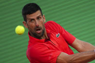 Serbia's Novak Djokovic returns the ball to Casper Ruud, of Norway, during a semifinals match at the Monte Carlo Tennis Masters tournament in Monaco, Saturday, April 13, 2024. (AP Photo/Daniel Cole)