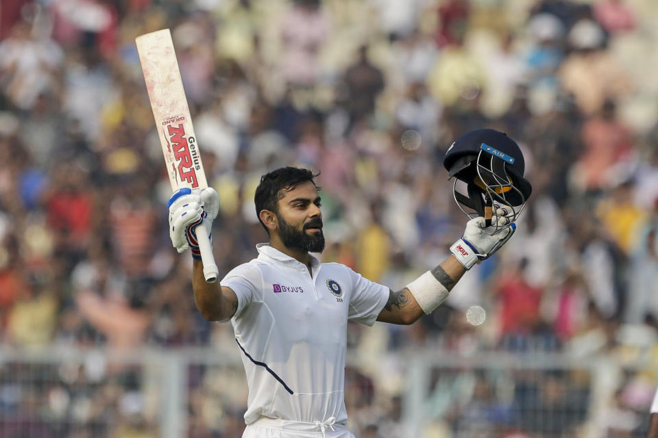 India's Virat Kohli celebrates scoring hundred runs during the second day of the second test cricket match between India and Bangladesh, in Kolkata, India, Saturday, Nov. 23, 2019. (AP Photo/Bikas Das)