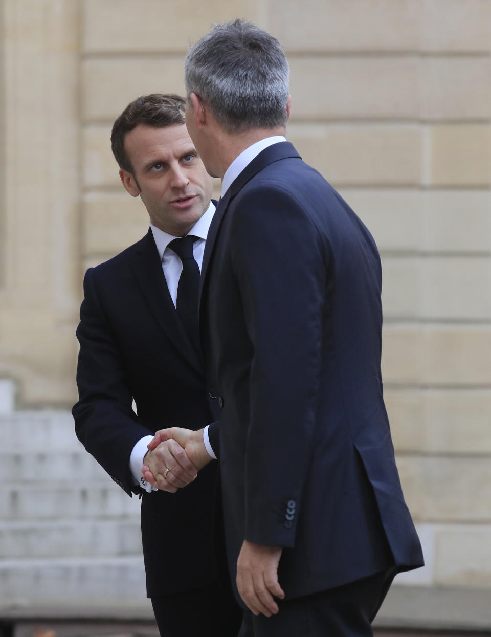 French President Emmanuel Macron, left, welcomes NATO Secretary General Jens Stoltenberg at the Elysee Palace in Paris, Thursday, Nov. 28, 2019. NATO chief Jens Stoltenberg is to meet in Paris with French President Emmanuel Macron, whose recent public statement that it is "brain dead" has shaken the military alliance. (AP Photo/Michel Euler)