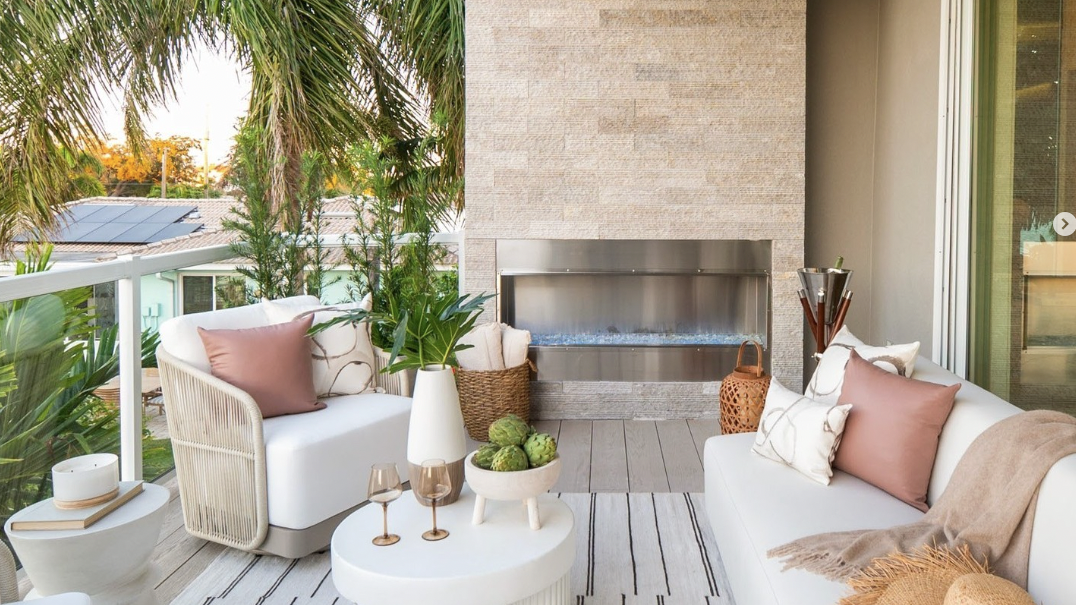 a living room with a white couch and a table with a white table and chairs and a white