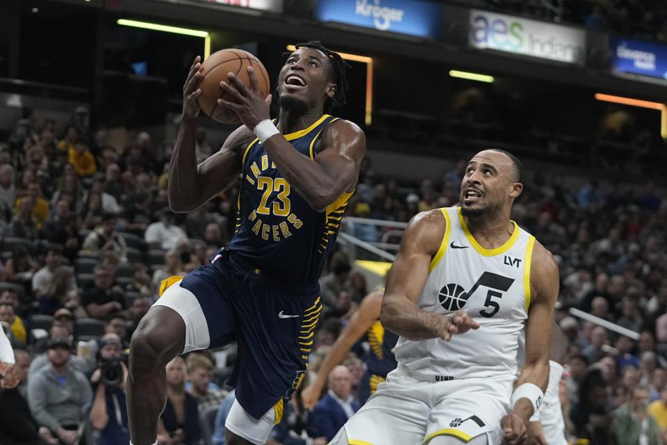 Indiana Pacers' Aaron Nesmith (23) puts up a shot against Utah Jazz's Talen Horton-Tucker (5) during the first half of an NBA basketball game, Wednesday, Nov. 8, 2023, in Indianapolis. (AP Photo/Darron Cummings)