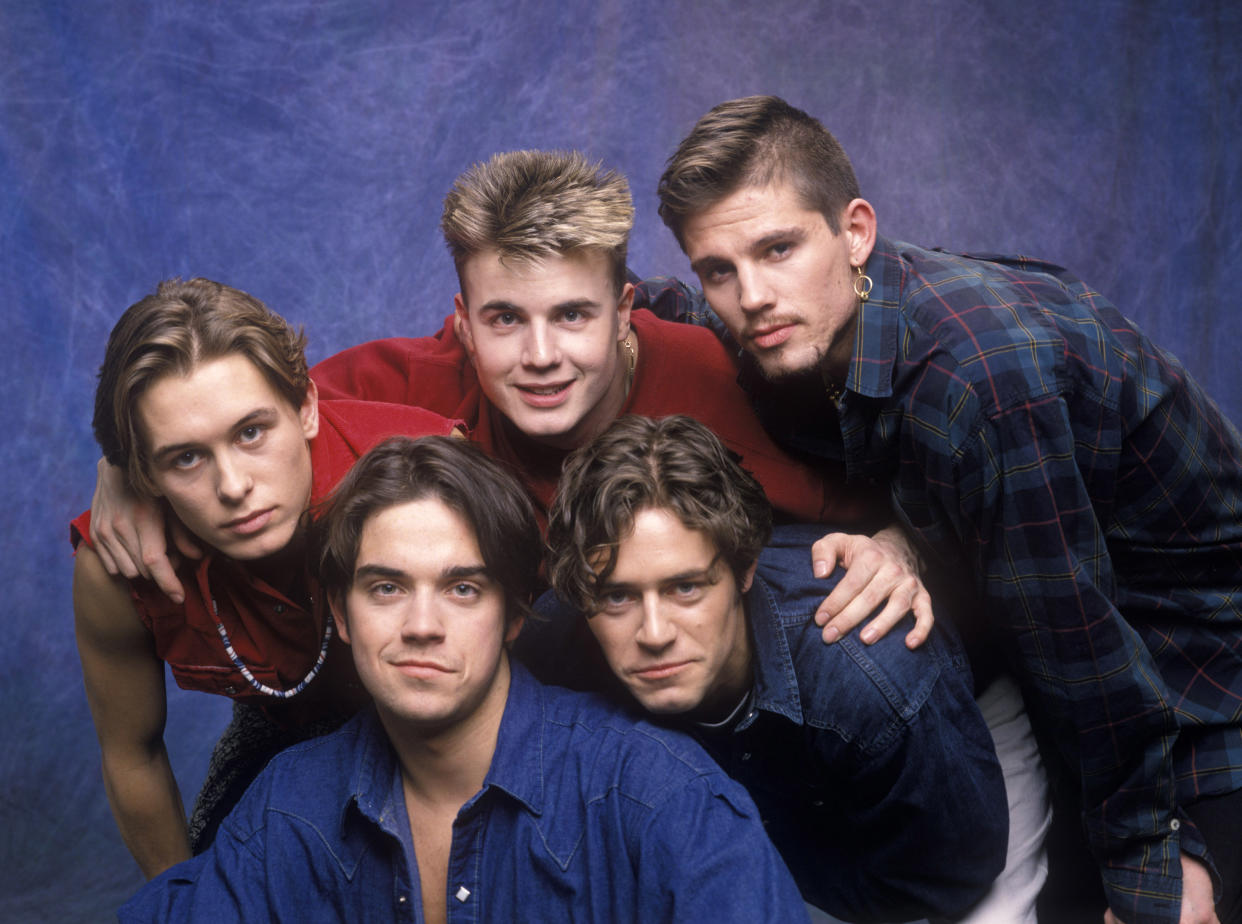 Robbie Williams, Mark Owen, Gary Barlow, Jason Orange and Howard Donald of  Take That (clockwise from lower left) (Photo by L. Busacca/WireImage)