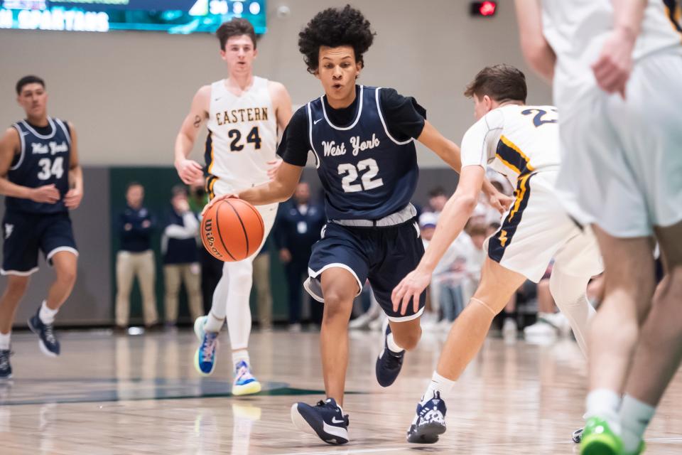 West York's Mark Walker (22) dribbles the ball in the second quarter of the YAIAA boys' basketball championship against Eastern York at York Tech, Friday, Feb. 18, 2022, in York Township. The Bulldogs won, 56-45.