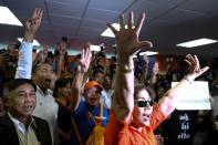 Supporters of Future Forward Party react after hearing the verdict from the Constitutional Court at the party headquarters in Bangkok