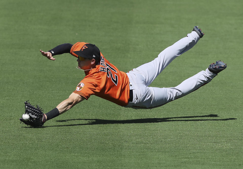 Baltimore Orioles outfielder Austin Hays can't quite get to a ball hit for an RBI single by Atlanta Braves Adam Duvall during the first inning in a MLB spring training baseball game Saturday, Feb. 22, 2020, in North Port, Fla. (Curtis Compton/Atlanta Journal-Constitution via AP)