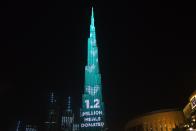 The Burj Khalifa, the world's tallest building, displays a message as part of the "World's Tallest Donation Box" campaign in Dubai, United Arab Emirates, Monday, May 11, 2020. The campaign raised money for meals to the hungry amid the coronavirus pandemic. (AP Photo/Jon Gambrell)