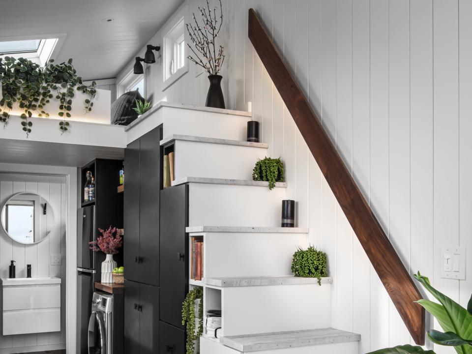 a staircase with integrated storage units leading up to a loft