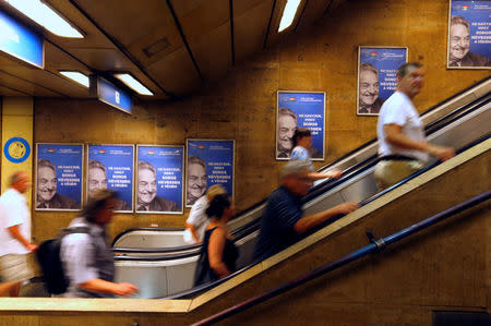 Hungarian government poster portraying financier George Soros and saying "Don't let George Soros have the last laugh" is seen at an underground stop in Budapest, Hungary July 11, 2017. REUTERS/Laszlo Balogh