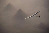 Solar Impulse 2, the solar powered plane, piloted by Swiss pioneer Andre Borschberg is seen during the flyover of the pyramids of Giza on July 13, 2016 prior to the landing in Cairo, Egypt in this photo released on July 13, 2016. Jean Revillard/SI2/Handout via Reuters