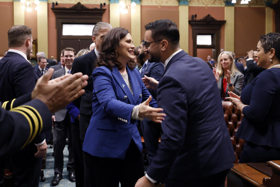 FILE - Michigan Gov. Gretchen Whitmer, left, greets state Rep. Abraham Aiyash, D-Hamtramck, before delivering her State of the State address to a joint session of the House and Senate, Jan. 24, 2024, at the state Capitol in Lansing, Mich. Two Democratic lawmakers from metro Detroit introduced a resolution Tuesday, Feb. 6, 2024 that condemns a Wall Street Journal opinion piece that they say is “racist and Islamophobic.” Dearborn state Rep. Alabas Farhat and Michigan House Floor Leader Abraham Aiyash also called on the publication to retract the article and apologize to the city of Dearborn in their resolution. The Wall Street Journal published an opinion article Friday titled “Welcome to Dearborn, America’s jihad capital." (AP Photo/Al Goldis, file)