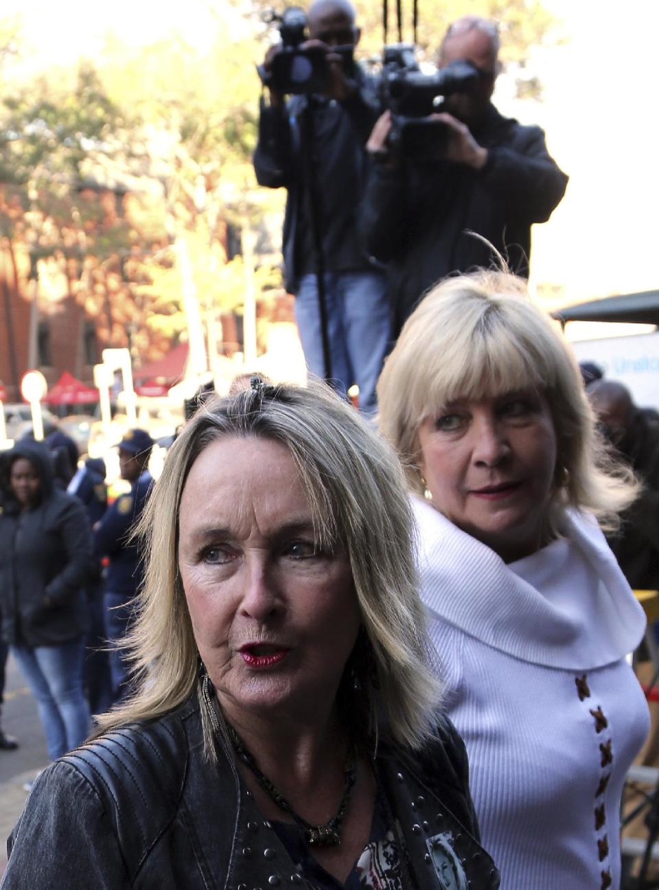 June Steenkamp, left, mother of Reeva Steenkamp, accompanied by an unidentified family friend, arrives for the Oscar Pistorius trail at the high court in Pretoria, South Africa, Wednesday, May 14, 2014. Pistorius is charged with murder for the shooting death of his girlfriend, Reeva Steenkamp, on Valentines Day in 2013. (AP Photo/Themba Hadebe)