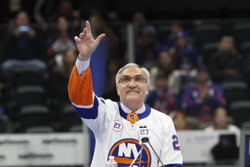 Former New York Islander John Tonelli, who was part of four Stanley Cup-winning Islanders teams, waves to the crowd during his jersey retirement ceremony Friday, Feb. 21, 2020, in Uniondale, N.Y. (AP Photo/Kathy Willens)