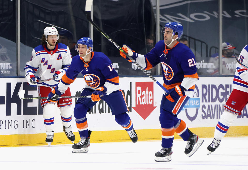 UNIONDALE, NEW YORK - APRIL 09: Kyle Palmieri #21 and Travis Zajac #14 of the New York Islanders skates against the New York Rangers at Nassau Coliseum on April 09, 2021 in Uniondale, New York. (Photo by Bruce Bennett/Getty Images)