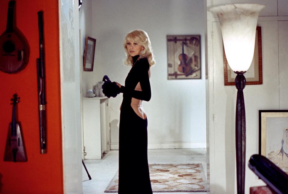 Mireille Darc in a backless black dress