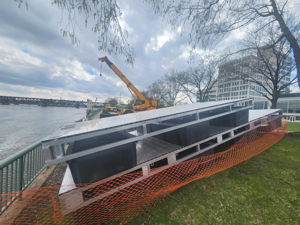 Construction crews build floating boat docks at Davis Park near the Embassy Suites by Hilton Rockford Riverfront Tuesday, April 25, 2023.