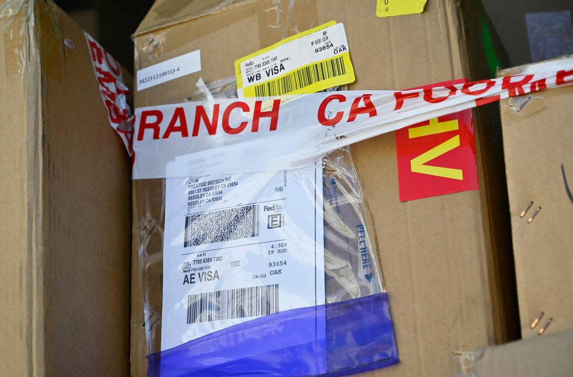 California Food and Drug Branch embargo tape is wrapped around cardboard boxes of medical test kits labeled for Prestige Biotech as cleanup continues at the closed warehouse location which had been illegally operated by Chinese company Prestige Biotech, seen Tuesday, August 1, 2023 in Reedley.