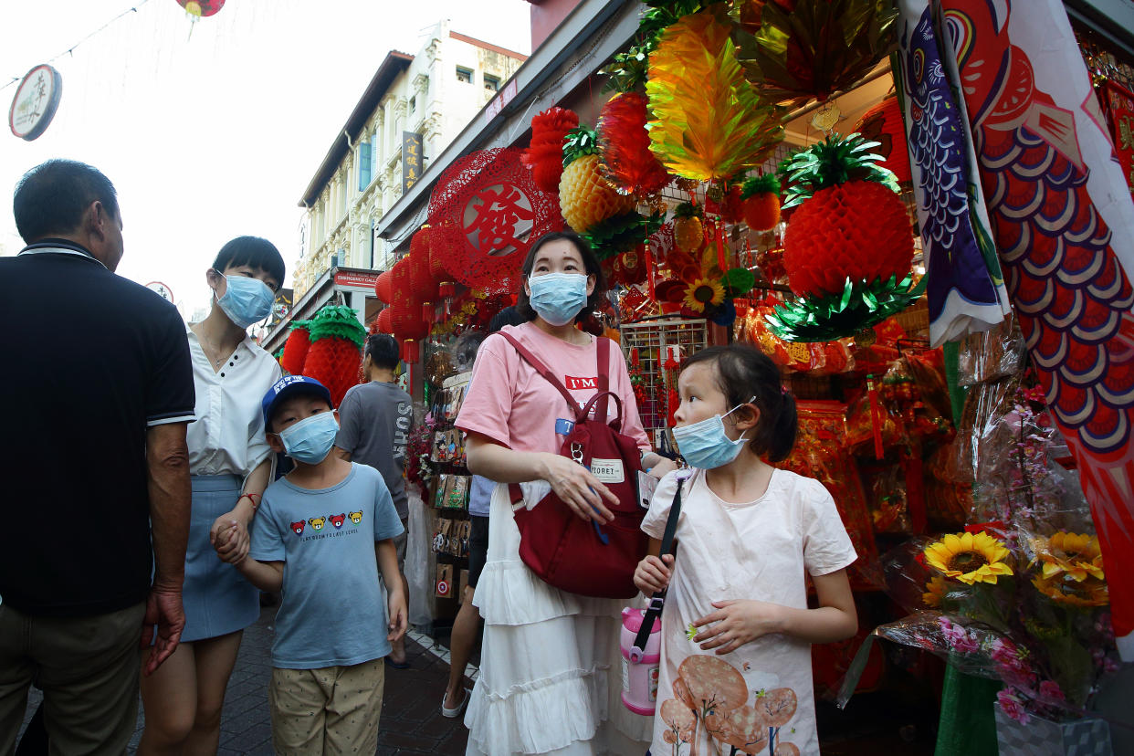 SINGAPORE - JANUARY 24:  Shoppers put on mask as they shop in Chinatown lunar new year bazaar on January 24, 2020 in Singapore. Singapore confirmed another two cases of the Wuhan viruses today, making a total of three, as Singapore prepares to usher in the Year of the Rat, one of the most anticipated holidays on the Chinese calendar. Also known as the Spring festival or the Lunar New Year, the celebrations last for about 15 days.  (Photo by Suhaimi Abdullah/Getty Images)