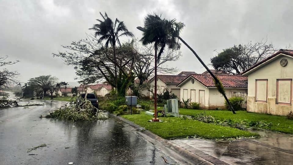 Downed tree branches litter a neighborhood in Yona, Guam, on Thursday. - Adam Brown/AP