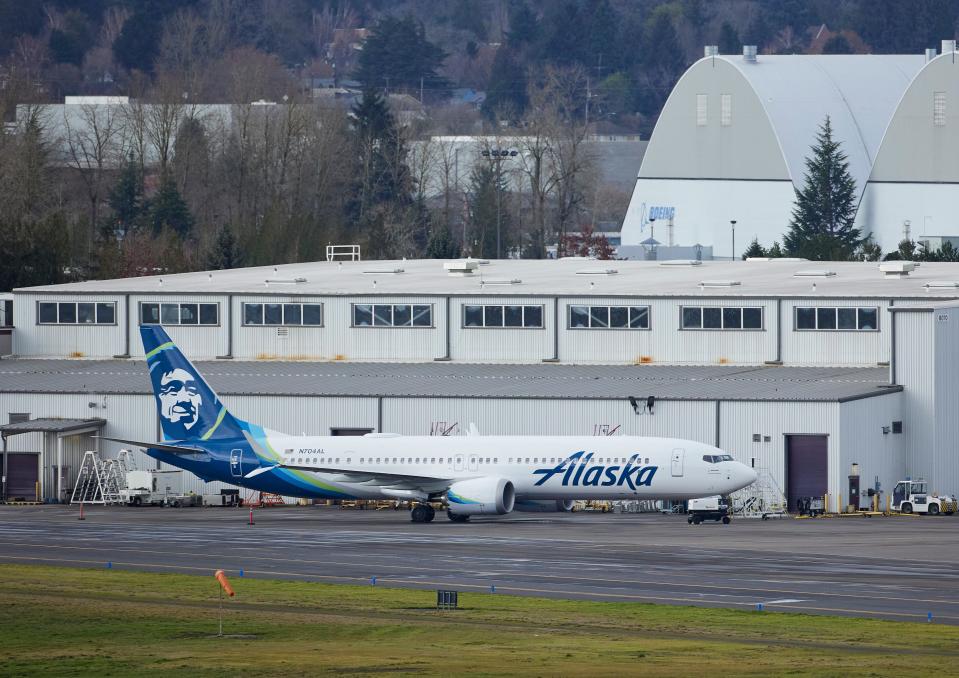 Alaska Airlines N704AL, a 737 Max 9 which made an emergency landing at Portland International Airport after a part of the fuselage broke off mid-flight on Friday, is parked at a maintenance hanger in Portland, Ore., Saturday, Jan. 6, 2024. (AP Photo/Craig Mitchelldyer) ORG XMIT: ORCM102