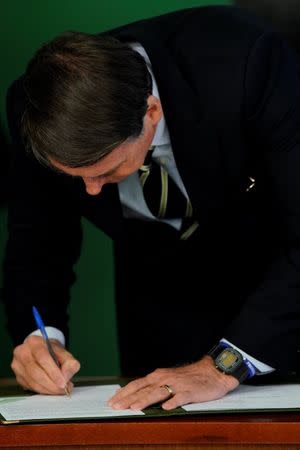 Brazil's President Jair Bolsonaro is seen during a signing ceremony of the decree which eases gun restrictions in Brazil, at the Planalto Palace in Brasilia, Brazil January 15, 2019. REUTERS/Ueslei Marcelino