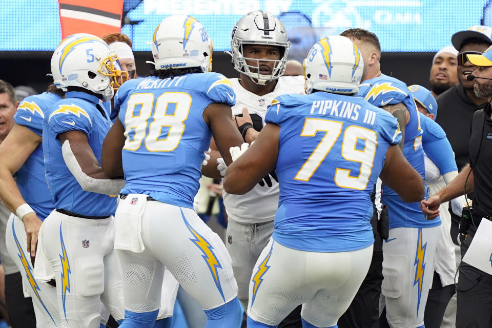 Las Vegas Raiders defensive tackle Jerry Tillery, center, is confronted by Los Angeles Chargers player after Tillery hit Chargers quarterback Justin Herbert late as Herbert ran out of bounds during the first half of an NFL football game Sunday, Oct. 1, 2023, in Inglewood, Calif. (AP Photo/Ryan Sun)