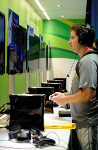 A man plays 'Gears of War 3' at Microsoft's Xbox 360 display