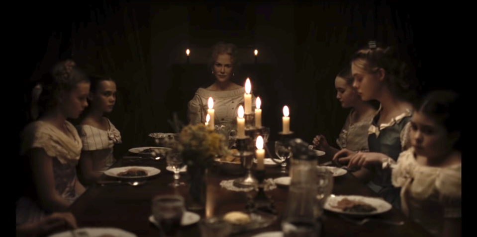 Nicole Kidman as "Martha" sits at the head of the table with her daughters after just poisoning a disruptive house guest in "The Beguiled"