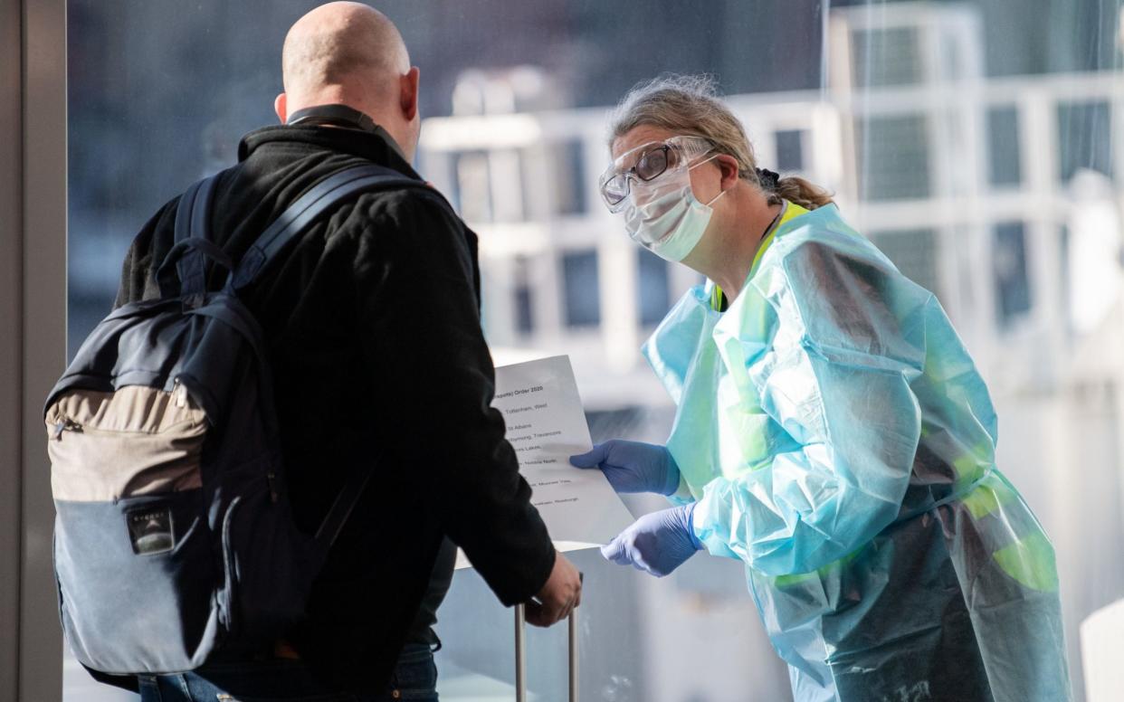 Passengers arriving from Melbourne are greeted by staff from New South Wales Health department - JAMES GOURLEY/EPA-EFE/Shutterstock 