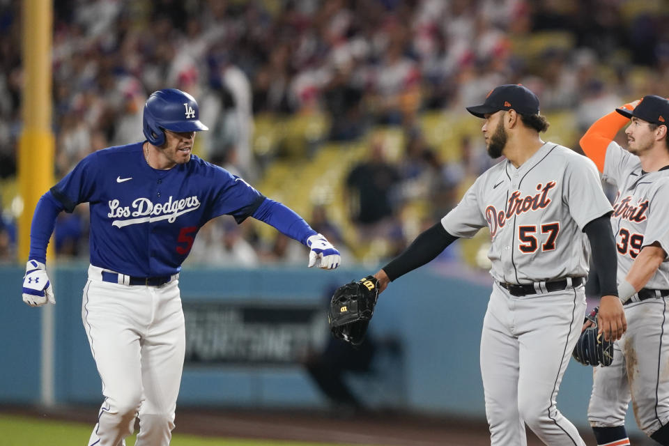 Los Angeles Dodgers' Freddie Freeman (5) greets Detroit Tigers starting pitcher Eduardo Rodriguez (57) after grounding out at first base during the first inning of a baseball game, Monday, Sept. 18, 2023, in Los Angeles. (AP Photo/Ryan Sun)