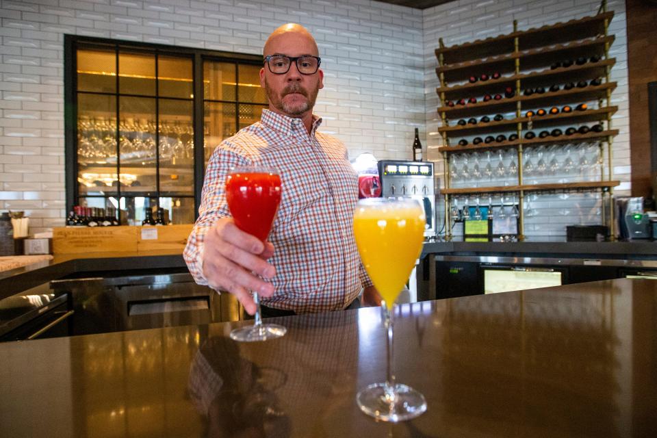 General Manager Wade Jaquess sets a frosé next to a mimosa Thursday, April 28, 2022, at Bin 23 Wine Bar, Bistro and Marketplace in Granger.