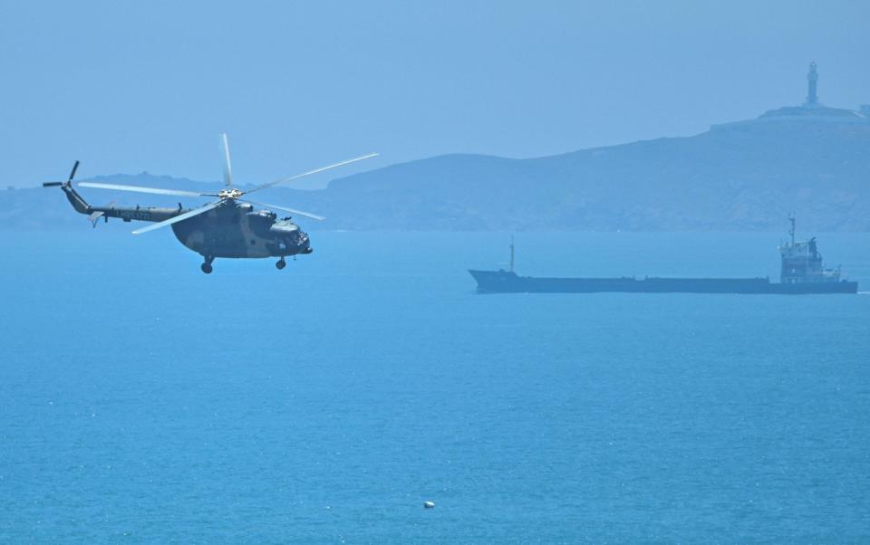 A Chinese military helicopter flies past Pingtan island, one of mainland China's closest point from Taiwan, in Fujian province on August 4, 2022 - HECTOR RETAMAL/ AFP
