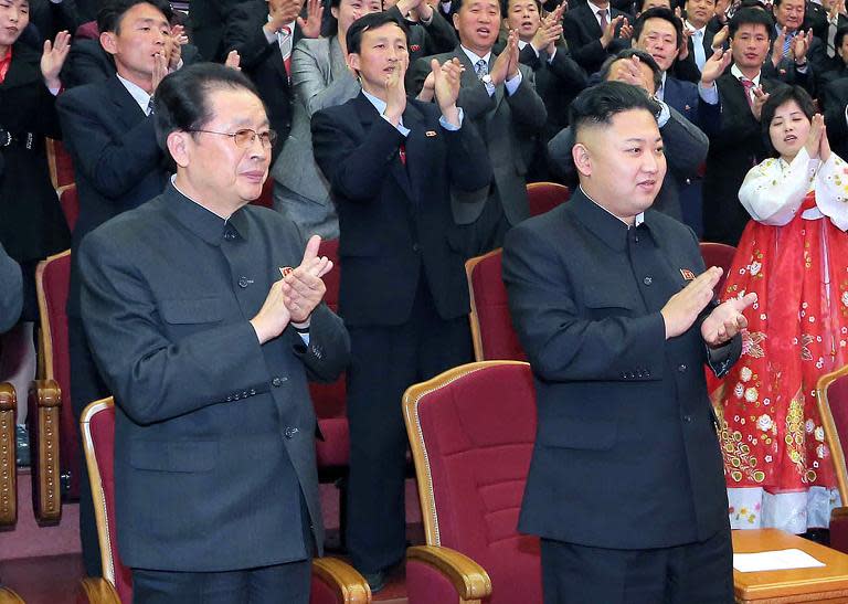 North Korean leader Kim Jong-Un (right) and Jang Song-Thaek attend a concert at the People's Theatre in Pyongyang, on April 15, 2013 along with his uncle, Jang Song-Thaek (L), who was executed this week for treason