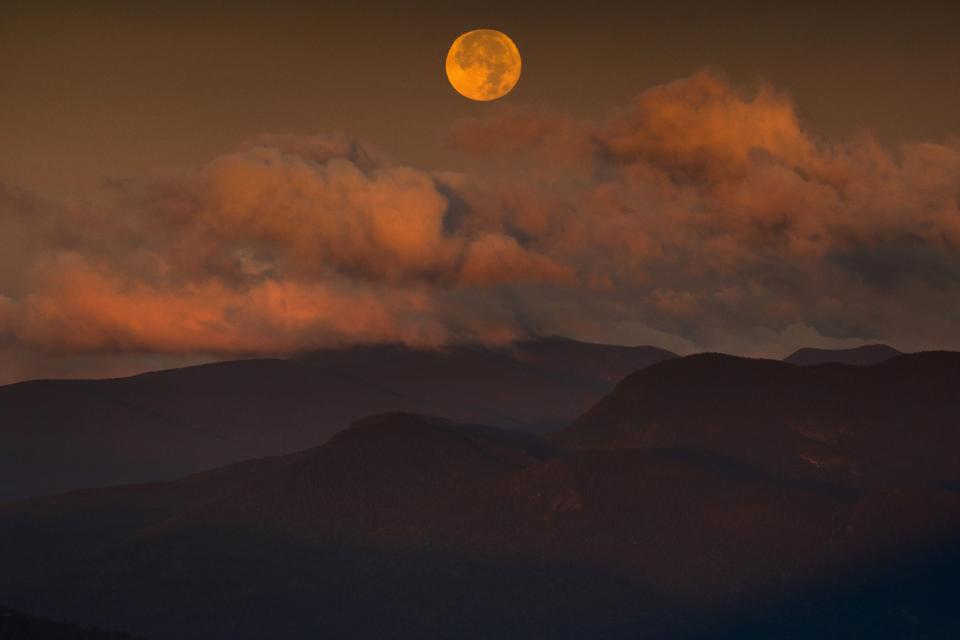 The blue supermoon sets over the White Mountain National Forest at sunrise, Thursday, Aug. 31, 2023, in Carroll County, New Hampshire. The next blue superman won’t occur until 2037. | Robert F. Bukaty, Associated Press